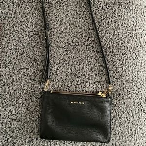 Michal kors black and gold crossbody bag.